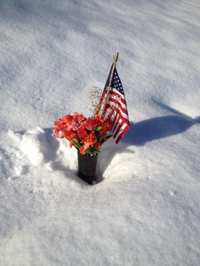 Fir Grove Cemetery Winter Snow photo of a flag in a vase in a cemetery