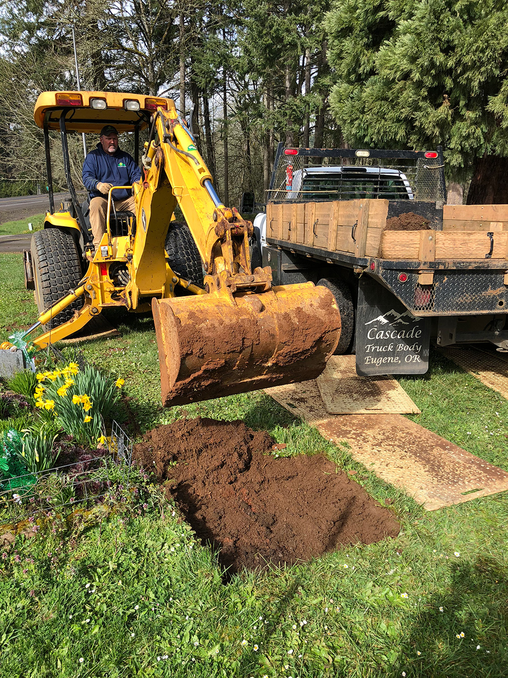 Lund Cemeteries Inc. Grave Opening photo of heavy machinery digging a grave in a cemetery